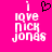 A bright pink background displays pixelated white text reading "i love nick jonas" with a black heart symbol above the 'i' on the left side, while the right side shows identical text without the heart.