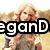 A pixelated image of a woman with long blonde hair wearing a gray top, partially obscured by large black text reading 'egand' on the left side.