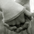 Black-and-white photo of hands holding a small object, with pink and gray text elements on white background.
