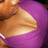 A static pixelated image shows a partial view of a figure with light brown skin and a purple garment against a dark background.