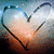 A pixelated heart-shaped icon with a gradient background transitioning from blue to orange, featuring a central light source and dark curved lines forming the heart outline.