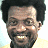 Pixelated image of a smiling person with dark curly hair and light skin, alongside blue text reading "I'm In Love" and "OriginalIcons.com" on black backgrounds.