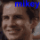 A pixelated image of a smiling person with dark hair, featuring the text 'mikey' in blue at the top left and white at the bottom left.