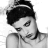 Black-and-white portrait of a person with dark hair styled up, wearing a headband and sleeveless top against white background; green text 'Original Icons .com' on solid green