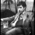 A 3x3 contact sheet of black-and-white animated frames showing a man in a suit with changing hand positions and red text overlays, set against a dark background with visible pixelation.