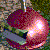 Pixelated heart-shaped icon with gradient purple and pink hues, featuring a bright white light effect on the right side against a blurred greenish background.