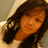 Pixelated close-up of a person with long dark hair, light skin tone, and reddish lips against a blurred background.
