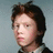 Pixelated image of a person with brown hair and a light-colored shirt against a gray background, surrounded by orange text blocks with red pixelated lettering.