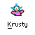 Pixelated character with blue star-shaped head, yellow face, orange nose, pink body, and black outline on gray background.