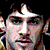 Pixelated image of a person with dark hair and light skin, alongside text on brown background.