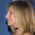 Pixelated profile view of a person with light brown hair against a solid blue background, showing side profile from shoulder up.