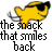 A pixelated yellow fish with a black eye patch and gray tail fin appears above text reading "the snack that smiles back" in bold, blocky letters.