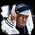 A 50x50 pixel animated buddy icon featuring a person in traditional Middle Eastern attire with white and blue headscarf, visible facial features including eyes and nose, and dark clothing, displayed as two sequential frames showing slight pose variation against black background.