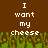 Brown background with white pixelated text reading "I want my cheese" repeated twice, green grass-like pixels at the bottom.