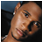 Pixelated close-up of a person's face with visible facial features and partial body, displayed as a static buddy icon.