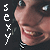 repeated pixelated faces with a dark background, each face showing a smiling expression and the word "sexy" in vertical text on the left side