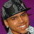 Pixelated image of a person wearing a dark cap and light shirt against purple background with repeated '3' text in white or red.