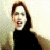 A person with reddish-brown hair appears in three distinct poses across a , wearing a black top with visible hand gestures and background variations