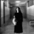 A black-and-white image of a figure in a long dark dress holding an object, with red text reading "Keep An Open Mind" below and "Spirits" on the right side.