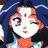 A pixelated anime-style character with blue hair and a red bindi on her forehead appears in the left frame of a 2x1 contact sheet, while the right frame displays "Anime IM" text above "cOm" text against a black background.