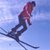 Pixelated static image of a skier in mid-air against a blue sky background, wearing red top and dark pants with ski poles extended.