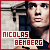 Pixelated static image of a person with red text reading NICOLAS BEHBERG over a blurred background, framed by a solid red border.