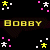 Pixelated yellow text "BOBBY" appears twice on a black background with scattered pink and white squares, surrounded by small star-like shapes in yellow and white.
