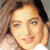 Static pixelated image of a person's face with light brown hair and visible facial features including eyes, nose, mouth, and ear, set against a neutral background.