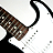 Pixelated image of a brown electric guitar with black accents against white background, showing partial body and neck.