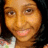 A pixelated image of a person with dark hair and light skin, wearing a white top with floral patterns, alongside yellow text elements on black backgrounds.
