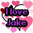 Pixelated graphic with purple text 'I love Jake' on black outlines, surrounded by pink hearts and a red bow on a white background.