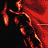 Pixelated static image of a red and orange figure with abstract shapes against black background, likely a stylized character or mascot in motion.