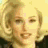 Four- of a person with blonde hair showing sequential facial expressions from neutral to smiling