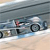 A pixelated static image shows a silver car with black wheels on a light brown surface, featuring a red and white detail on the side.