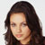 Static pixelated image of a person with long dark hair against a light background, rendered in low resolution with visible dithering and color blending.