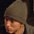 Static 50x50 pixel buddy icon showing a person wearing a brown beanie hat with visible facial features and partial clothing against dark background.