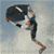 A 4-frame animated contact sheet showing a surfer performing tricks on a surfboard against a blue sky and ocean background.