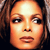 Pixelated close-up of a person's face with light brown hair, neutral expression, and warm-toned skin under bright lighting.