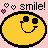 Pixelated yellow smiley face with black outline and closed eyes, surrounded by pink hearts and 'smile!' text on a light pink background.