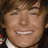 Pixelated image of a person with brown hair and a white collar, set against a purple background with cyan text reading "What time is it??", "Time for him to", and "ASK ME OUT!!".