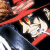Pixelated image of a character with red hair and white clothing against dark background, featuring visible pixelation artifacts.