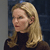 Pixelated image of a person with long blonde hair wearing a dark turtleneck sweater against a dark blue background.