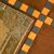 A static pixelated image shows a diagonal arrangement of orange star shapes on dark gray and brown backgrounds with visible pixelation.