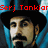 Pixelated image of a person with dark hair and mustache, wearing blue clothing, under red text reading 'Serj Tankian'.