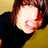 A pixelated image of a person with brown hair wearing a black top and yellow garment, with blue text reading "sexy beast" on the right side.