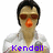 Pixelated image of a person with dark hair, brown sunglasses, and an orange nose wearing a white shirt with purple text reading "Kendall".