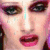 Static 50x50 pixel icon showing a close-up of a person's face with pink and purple tones, visible eyes, nose, mouth, and lips.