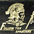 Pixelated image of a skeletal figure with a skull-like head, wearing a hooded cloak, holding a scythe, set against a dark background.