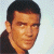 Pixelated image of a person with short dark hair against light background, next to green text reading Original Icons .com in bright green pixel font.