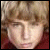 Two side-by-side pixelated images of a person with light brown hair, one showing the face directly and the other showing profile view.